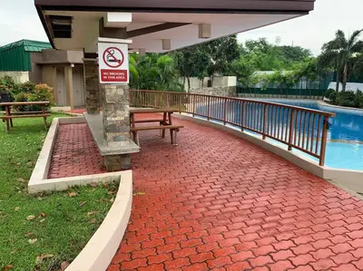 a red brick walkway next to a swimming pool at Cozy Place Anuva Residences in Manila