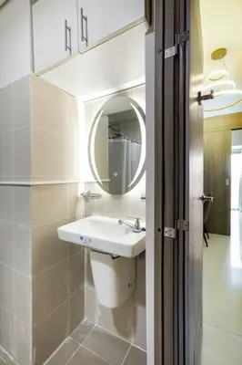 a bathroom with a sink and a mirror at Luxury Sunset Views and Prime Location near CCP MOA with WIFI Parking in Manila