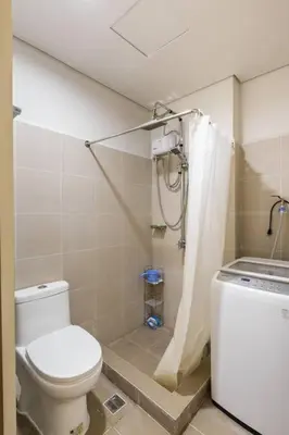 a bathroom with a toilet and a shower at Luxury Sunset Views and Prime Location near CCP MOA with WIFI Parking in Manila