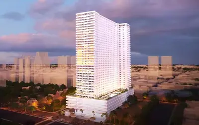a tall white building in a city at Luxury Sunset Views and Prime Location near CCP MOA with WIFI Parking in Manila
