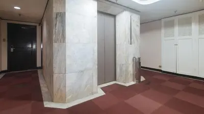 a hallway with a wall of marble at Sunette Tower Makati in Manila