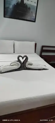 a swan decoration on a bed in a bedroom at DUCK INN AND RESTAURANT in Manila