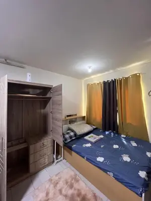 a small bedroom with a bed and a large cabinet at Dream Condo in Santa Rosa in Santa Rosa