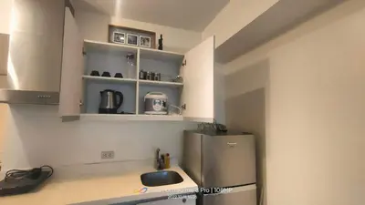 a kitchen with a sink and a refrigerator at Azure Urban Resort with WIFI and Netflix in Manila