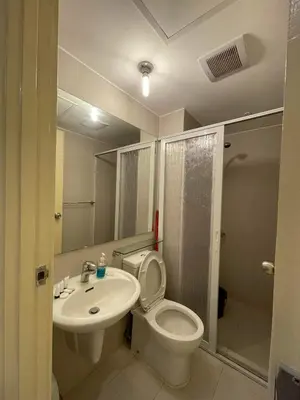 a bathroom with a toilet and a sink and a shower at Azure Urban Resort with WIFI and Netflix in Manila