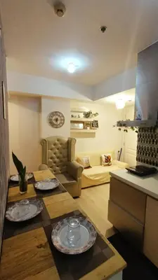 a living room with two plates on top of a table at Azure Urban Resort with WIFI and Netflix in Manila
