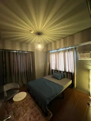 a bedroom with a bed and a ceiling at C-UY Realtae in Manila