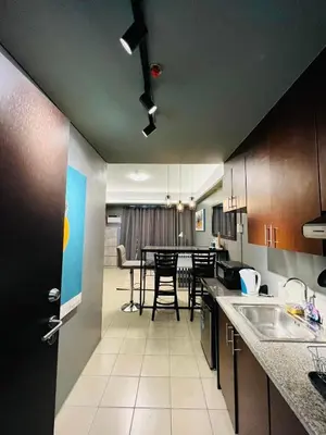 a kitchen and dining room with a dining table at C-UY Realtae in Manila