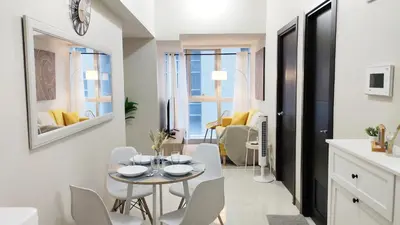 a kitchen and dining room with a table and chairs at Uptown Parksuites BGC 2 bedroom 2 bath in Manila