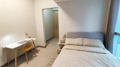 a small bedroom with a bed and a desk at Uptown Parksuites BGC 2 bedroom 2 bath in Manila