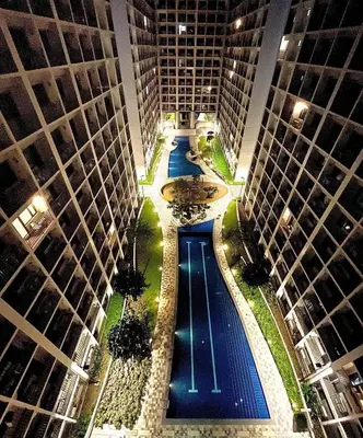 an overhead view of a pool between two tall buildings at Shore Residence D11 Shortwalk Mall Of Asia/ In't Airport in Manila