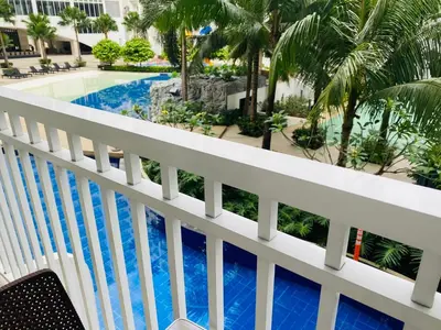 a view of the pool from the balcony of a resort at Shore Residence D11 Shortwalk Mall Of Asia/ In't Airport in Manila