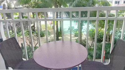 a purple table and chairs on a balcony at Shore Residence D11 Shortwalk Mall Of Asia/ In't Airport in Manila