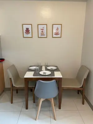 a dining room with a table and two chairs at One Uptown Residence BGC in Manila