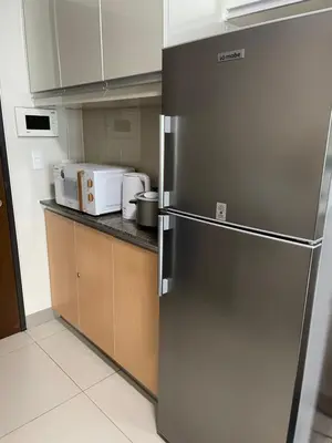 a stainless steel refrigerator in a small kitchen at One Uptown Residence BGC in Manila