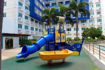 a playground in front of a large building at SEA Residences in Pasay near Mall of Asia in Manila