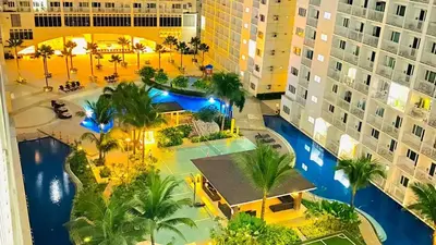 an aerial view of a resort with a pool at Shore Residences MOA Staycation in Manila