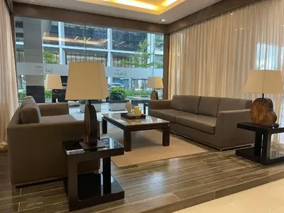 a living room with a couch and a table at Shore Residences MOA Staycation in Manila