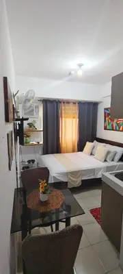 a room with a bed and a table with chairs at JJMC HOMESTAY 22 With netflix and fast wifi in Manila