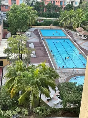 an overhead view of a large pool with people in it at Borbon's Condo Suite in Manila