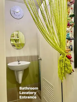 a bathroom with a sink and a shower curtain at Borbon's Condo Suite in Manila