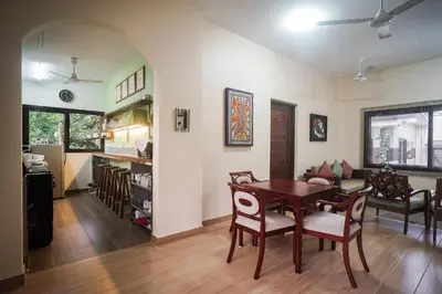 a dining room and living room with a table and chairs at Tagaytay Foothills Cherimoya Farm Staycation in Biboyan