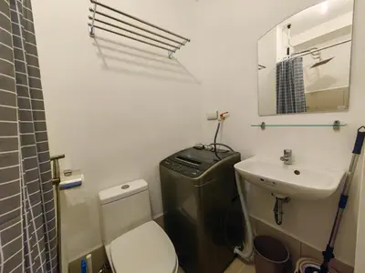 a small bathroom with a toilet and a sink at Crib's nr.BGC in Manila