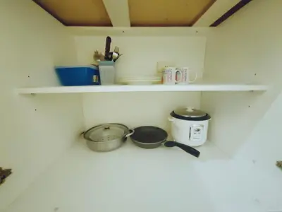 a shelf with two pots and pans on it at Crib's nr.BGC in Manila