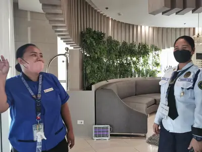 two people standing in a room wearing masks at Crib's nr.BGC in Manila