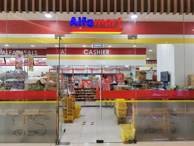 a grocery store with a cashier sign on the wall at Crib's nr.BGC in Manila
