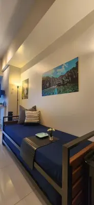 a bedroom with a blue bed in a room at 8U Pristine & Cozy Stay at Uptown Mall BGC across Mitsukoshi with FREE Parking and Balcony in Manila