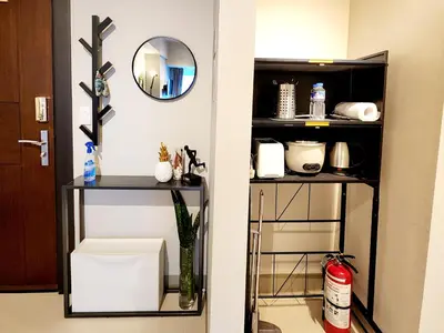 a room with a shelf with a toilet and a mirror at 8U Pristine & Cozy Stay at Uptown Mall BGC across Mitsukoshi with FREE Parking and Balcony in Manila
