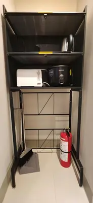 a black shelf with a fire extinguisher in a room at 8U Pristine & Cozy Stay at Uptown Mall BGC across Mitsukoshi with FREE Parking and Balcony in Manila