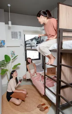 a group of girls sitting on a bunk bed at The Grid Co-Living Managed by HII in Manila