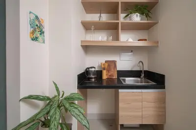 a small kitchen with a sink and a plant at The Grid Co-Living Managed by HII in Manila