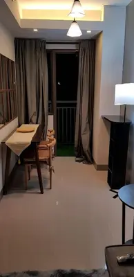 a living room with a chair and a table at BayLIfe Escape in Manila