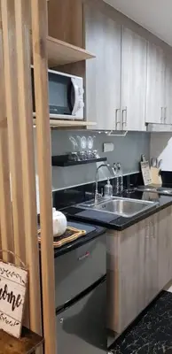 a kitchen with a sink and a microwave at BayLIfe Escape in Manila