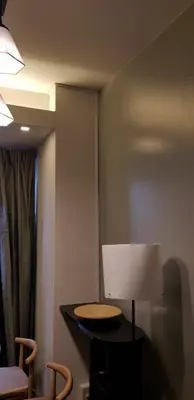 a room with a table with a lamp and two chairs at BayLIfe Escape in Manila