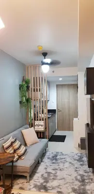 a living room with a couch and a table at BayLIfe Escape in Manila