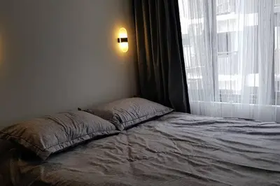 a bed in a bedroom with a large window at BayLIfe Escape in Manila