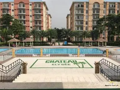 a large swimming pool in a city with tall buildings at CHATEAU ELYSEE A11 Near Sm Mall and Airport in Manila