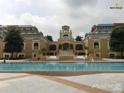 a large building with a pool in front of it at CHATEAU ELYSEE A1 near airport mall Free wifi in Manila