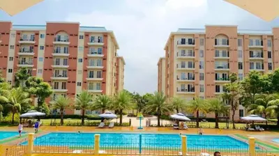 a large swimming pool in front of two large buildings at CHATEAU ELYSEE A1 near airport mall Free wifi in Manila