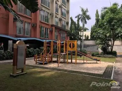 a playground in front of a tall building at CHATEAU ELYSEE A1 near airport mall Free wifi in Manila