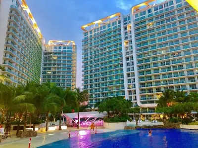 a pool in front of two tall buildings at Azure Residence A8 Near Sm Mall/Airport +free wifi in Manila