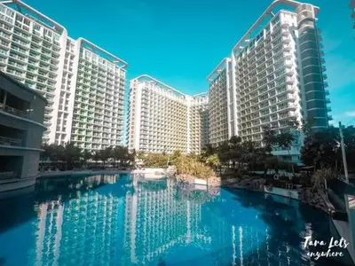 a large building with a large pool of water in front at Azure Urban Residence A10 Near Airport and SM Bicutan+ Free wifi in Manila