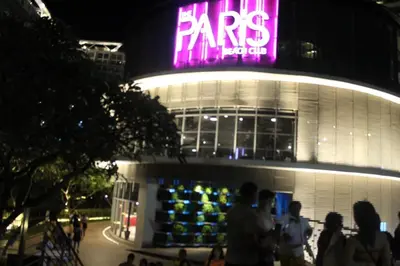a group of people standing outside of a store at night at Azure Urban Residence A10 Near Airport and SM Bicutan+ Free wifi in Manila
