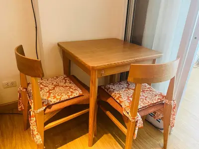 a wooden table and two chairs next to a table at Azure Urban Residence A10 Near Airport and SM Bicutan+ Free wifi in Manila