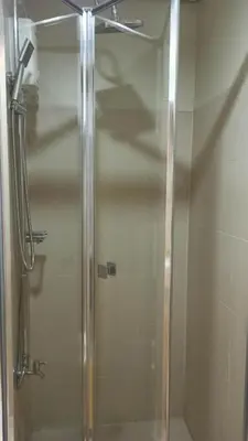 a shower with a glass door in a bathroom at Cozy 1Br with Netflix & Balcony Pool View Condo in Manila