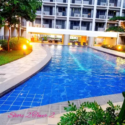 a swimming pool in the middle of a building at Shore Residence Staycation unit at Mall of Asia in Manila